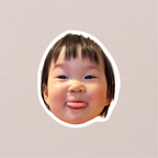 A single face-cutout sticker of a toddler poking their tongue out, cut with a clean white border