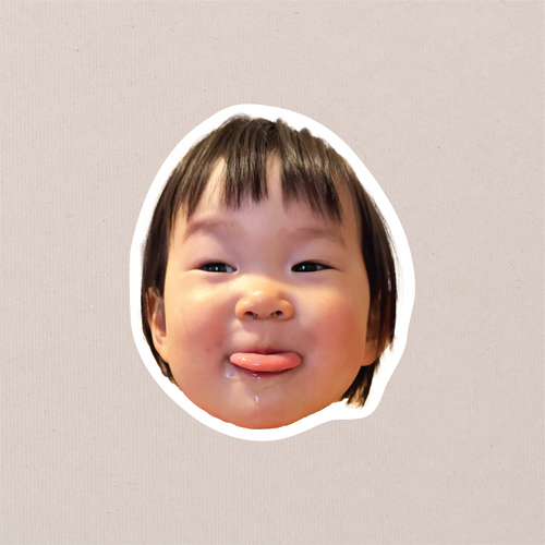 A single face-cutout sticker of a toddler poking their tongue out, cut with a clean white border