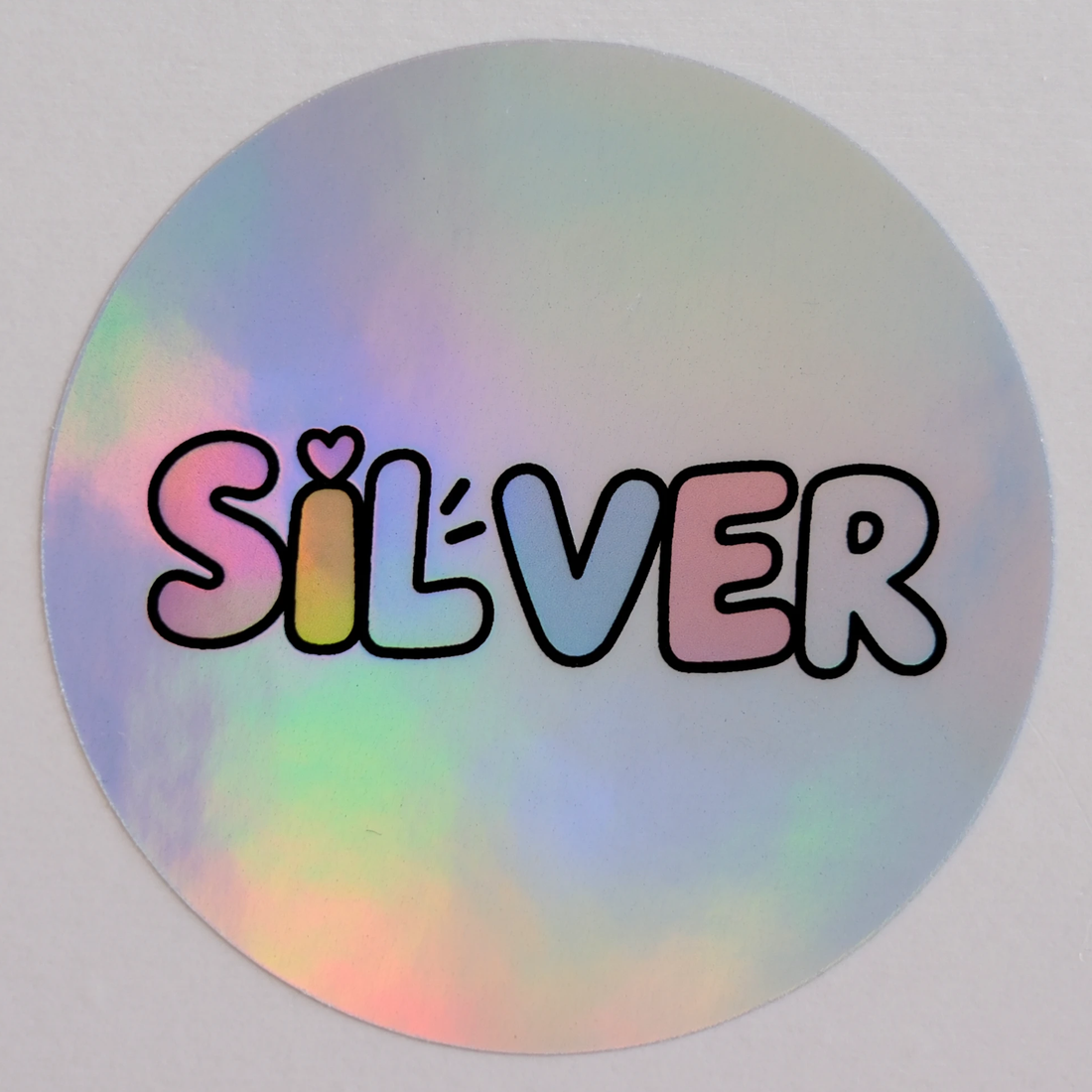 Silver sample: a round sticker printed with SILVER in bubble letters