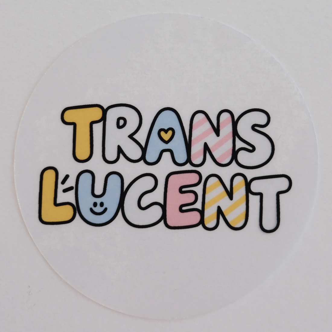 Translucent sample: a round sticker printed with TRANSLUCENT in bubble letters