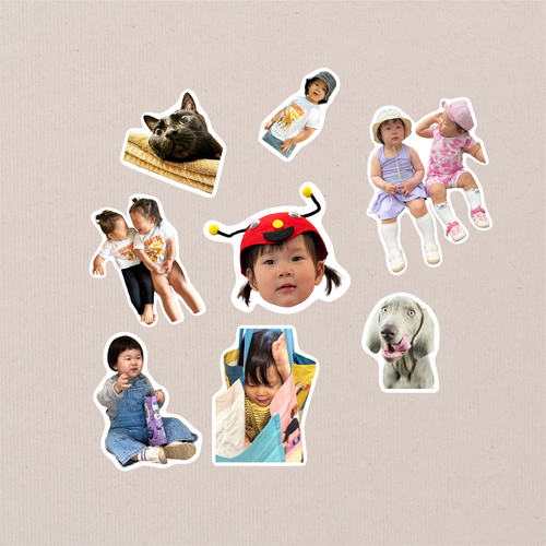 The eight Package Full designs cut out on kraft paper, mixing children with a black cat and a grey dog